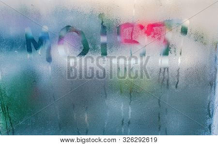 Moist Word Written On Wet Window. High Level Of Dampness In Apartment. Window Glass With High Air Hu