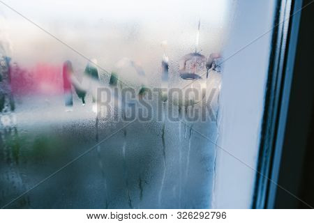Moist Word Written On Wet Window. High Level Of Dampness In Apartment. Window Glass With High Air Hu