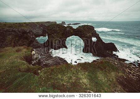 Amazing Seascape, Gatklettur Basalt Rock Arch At The Volcanic Cliff, Atlantic Coast Of Arnarstapi In