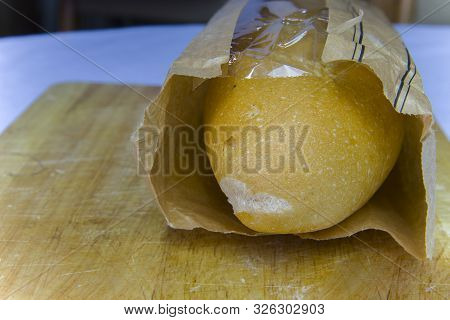Fresh Baguette In A Paper Bag Closeup Copy Space.