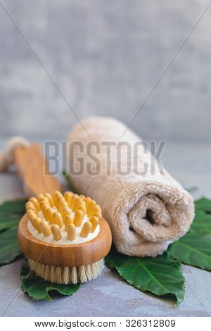 Body Spa Treatment Bamboo Brush With Bathtowel On Green Tropical Leaf, Concrete Background