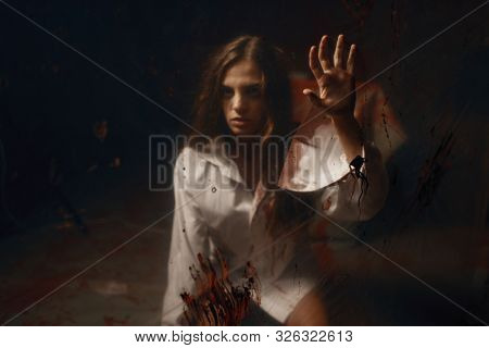 Victim with with bloody hands in hospital basement
