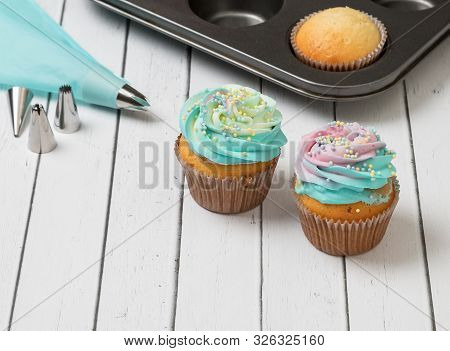 Sponge Cupcakes Decorated With Light Cream. Pastry.