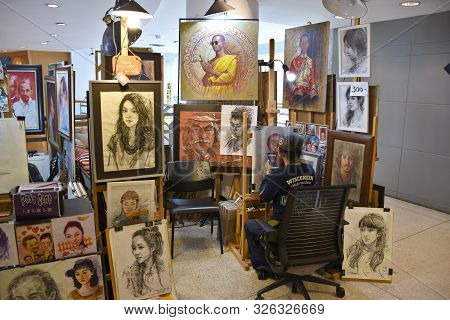 Bangkok, Thailand 08.23.2019: A Thai Artist Is Drawing A Realistic Portrait With Colored Pencils On 