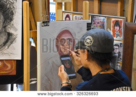 Bangkok, Thailand 08.23.2019: A Thai Artist Is Drawing A Realistic Portrait With Colored Pencils On 