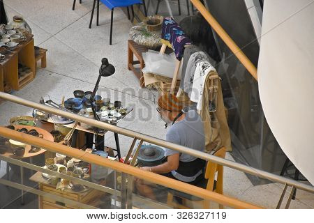 Bangkok, Thailand 08.23.2019: A Thai Artist Is Making A Clay Bowl Very Precisely At The Bangkok Art 