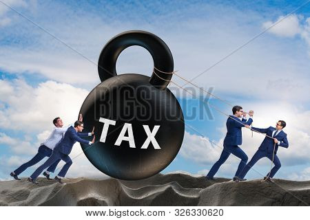 Businessman pulling kettlebell in tax concept