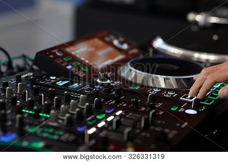 Dj Using A Sound Mixer Controller To Play Music. Selective Focus.