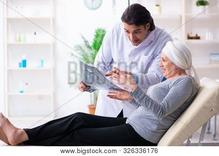 Young male doctor and female oncology patient