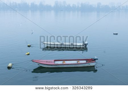 Two Fishing And Rowing Boats On Zemun Quay (zemunski Kej) On A Foggy Dusk In Winter Over The Danube 