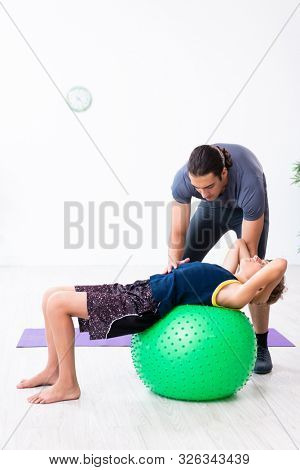 Young father and his son doing exercises