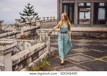 Woman Tourist In Abandoned And Mysterious Hotel In Bedugul. Indonesia, Bali Island. Bali Travel Conc