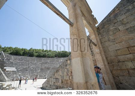 Epidaurus Greece - July 19 2019; Ancient Epidaurus Theatre Stone Seating Rows With Modern Numbers Ad