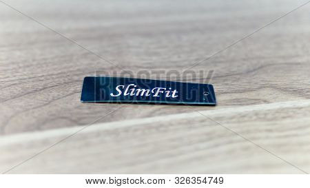 Close Up View Of Slim Fit Tag For Jeans.