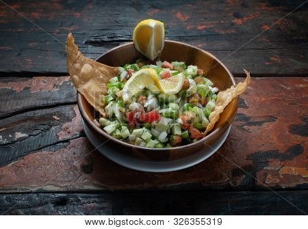 Turkish Gavurdagi Salad with walnut isolated on rustic wooden kitchen table