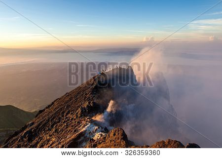 Merapi Volcano Crater Rim With People At Sunrise.