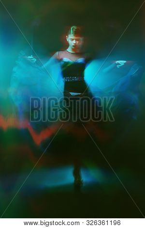 Beautiful girl performs Latino dance with expression. Professional dancer in motion. Beauty, fashion.