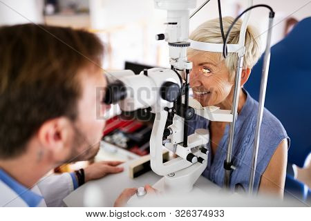 Senior Woman Taking An Eyesight Test Examination At An Optician Clinic