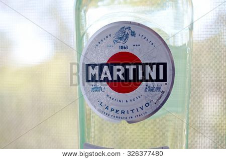 Kharkov, Ukraine - September 23, 2019: Bottle Of Vermouth Martini Rossi Close Up Logo On A Green Tre