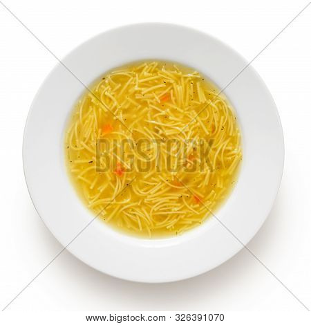 Instant Chicken Noodle Soup In A White Ceramic Soup Plate Isolated On White. Top View.