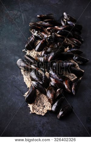 Fresh Uncooked Raw Big Mussels On Dark Background