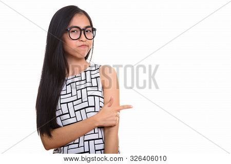 Young Asian Teenage Nerd Girl Pointing Finger While Looking Upse