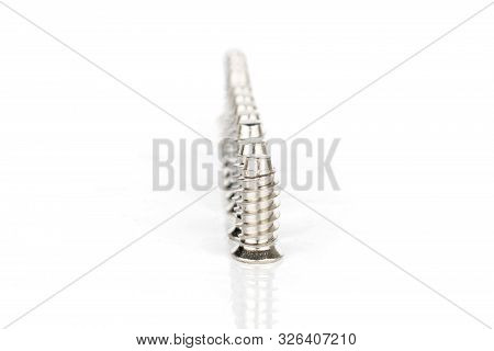 Lot Of Whole Metallic Glossy Bolt In Row Isolated On White Background