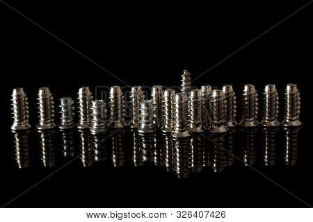Lot Of Whole Metallic Glossy Bolt In Row Isolated On Black Glass