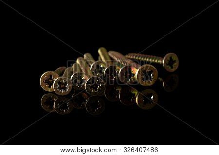 Group Of Nine Whole Metallic Glossy Bolt Isolated On Black Glass