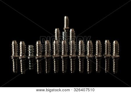 Group Of Seventeen Whole Metallic Glossy Bolt Isolated On Black Glass