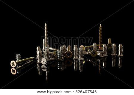 Lot Of Whole Metallic Glossy Bolt Isolated On Black Glass