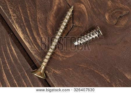 Group Of Two Whole Metallic Glossy Bolt Flatlay On Brown Wood