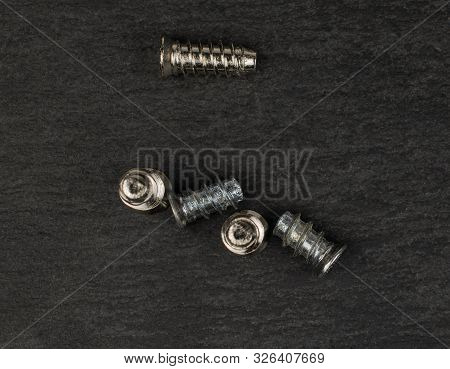 Group Of Five Whole Metallic Glossy Bolt Flatlay On Grey Stone