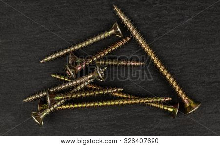 Lot Of Whole Metallic Glossy Bolt Flatlay On Grey Stone