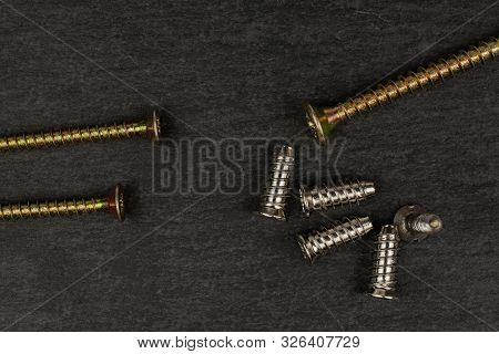 Group Of Eight Whole Metallic Glossy Bolt Flatlay On Grey Stone