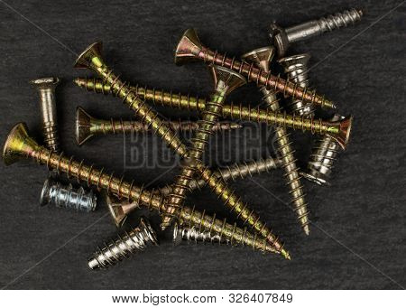 Lot Of Whole Metallic Glossy Bolt Flatlay On Grey Stone