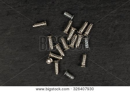 Lot Of Whole Metallic Glossy Bolt Flatlay On Grey Stone