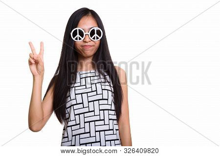 Young Asian Teenage Girl Giving Peace Sign While Wearing Sunglas