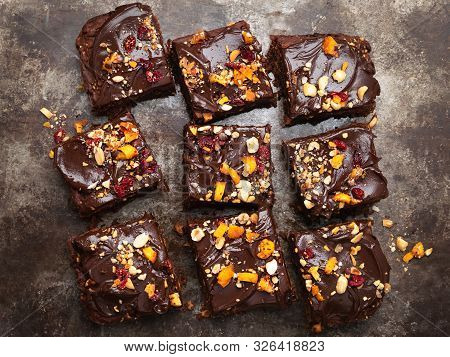 Chocolate Brownie Cake, Dessert With Nuts And Fruits On Dark Background, Directly Above. Vegan, Diet