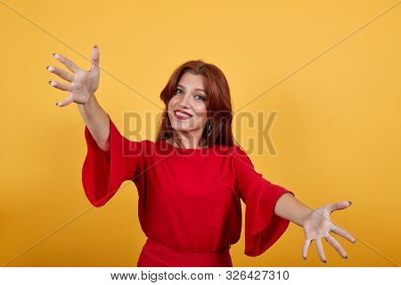 Happy Girl Smiling, Holding Hands Widely Opened And Shows Gesture Of Openess. Woman In Delightful Dr