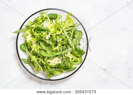 Green Salad Leaves Mix. Baby Spinach Leaves, Arugula And Frieze On White Stone Background. Top View 