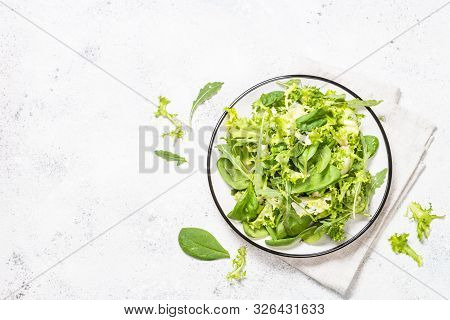 Green Salad Leaves Mix. Baby Spinach Leaves, Arugula And Frieze On White Stone Background. Top View 