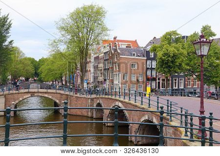 Keizersgracht And Reguliersgracht Canal In Amsterdam, Netherlands. Canalside Architecture.