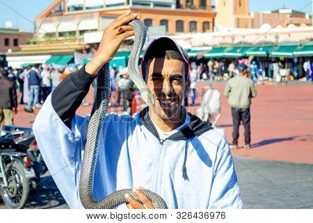 Morocco. Marakesh. December 9, 2018. A Young Man With A Snake In His Hands. The Tamer Of Snakes. Mor