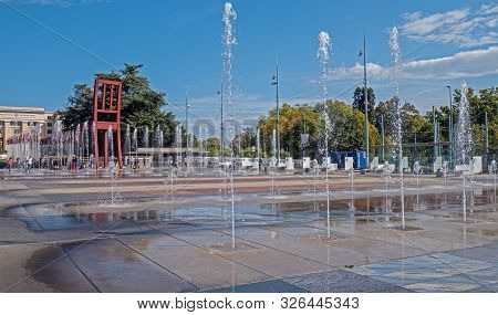 Geneva, Switzerland - September 22 2019:  The Water Fountains And Landmark Broken Chair Sculpture At