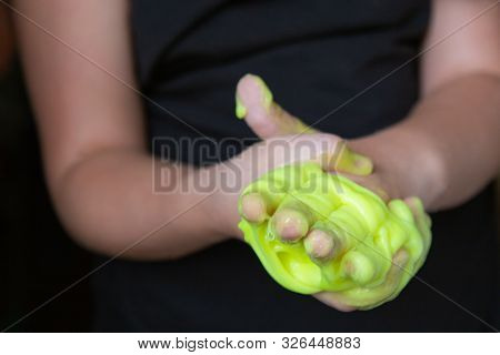 Kid Playing Handmade Toy Called Slime Green Color, Selective Focus On Slime, Teenager Having Fun And