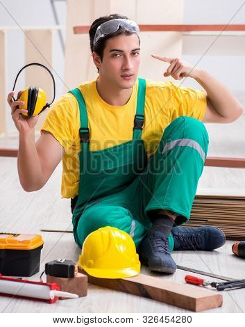 Worker showing the importnace of wearing noise cancelling headph