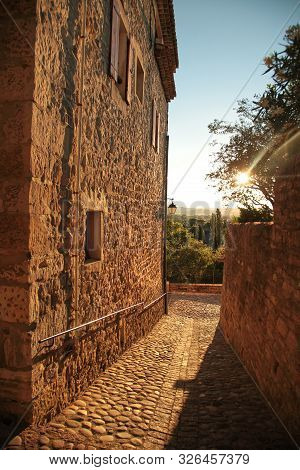 Narrow Street With Stone Pavement Of Old Town Of Barjac. European Old Town At Sunset, South France