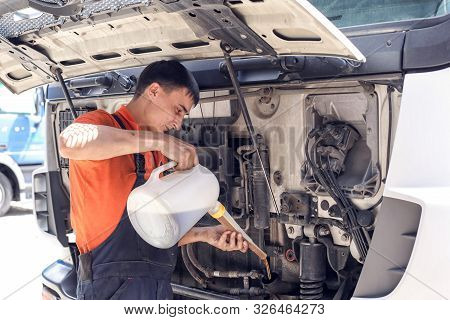 Mechanic Changes Engine Oil And Diesel Truck Filter