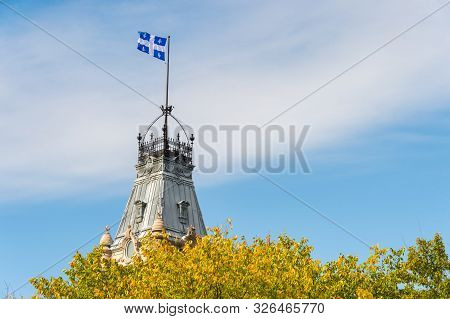 Quebec Flag At The Top Of The Quebec Parliament Building In Quebec City.